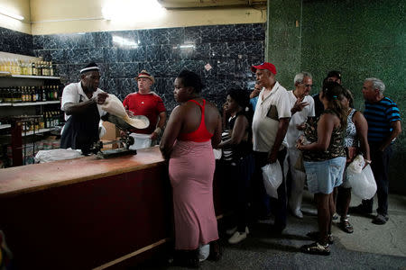 People wait in line to buy rice in a state store in downtown Havana, Cuba, May 10, 2019. REUTERS/Alexandre Meneghini