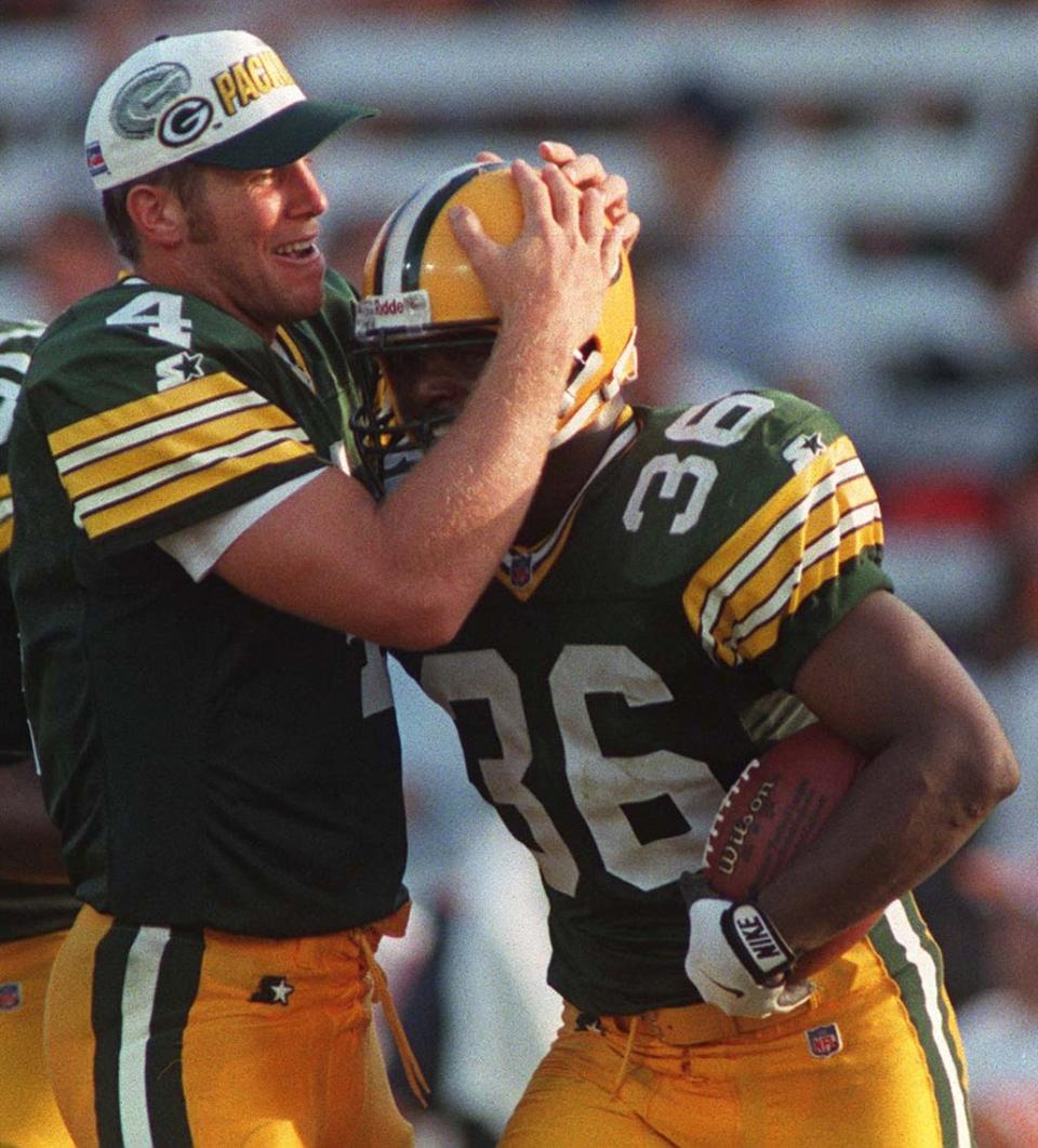 Packers quarterback Brett Favre congratulates LeRoy Butler on his second interception of the game in the third quarter of their game against the Buccaneers, Sept. 1, 1996 in Tampa. The Packers won 34-3.