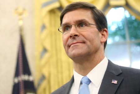 Mark Esper waits to be sworn in as the new Secretary of Defense in the Oval Office of the White House in Washington