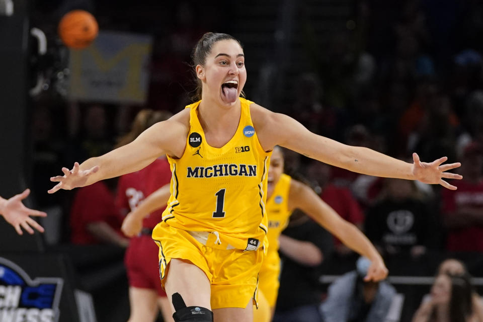 Michigan's Amy Dilk (1) celebrates a 52-49 victory over South Dakota following a college basketball game in the Sweet 16 round of the NCAA women's tournament Saturday, March 26, 2022, in Wichita, Kan. (AP Photo/Jeff Roberson)