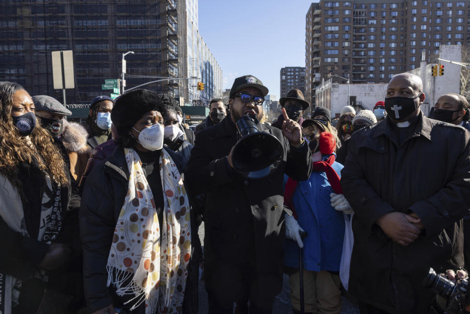 People gather for a news conference organized by the National Action Network near the scene of a shooting the day before, in the Harlem neighborhood of New York, Saturday, Jan. 22, 2022. (AP Photo/Yuki Iwamura)