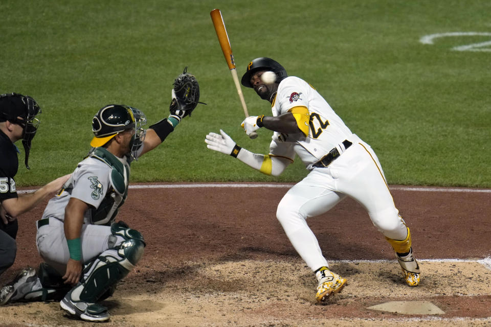 Pittsburgh Pirates' Andrew McCutchen (22) gets out of the way of a fastball from Oakland Athletics starting pitcher Shintaro Fujinami during the sixth inning of a baseball game in Pittsburgh, Monday, June 5, 2023. (AP Photo/Gene J. Puskar)