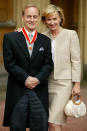FILE - In this June 25, 2004 file photo, journalist Harold Evans poses for a photo with his wife Tina Brown, after he was knighted by the Prince of Wales for service to journalism. Evans, the charismatic publisher, author and muckraker, has died at 92. His wife, fellow author-publisher Tina Brown, said he died of congestive heart failure, it was reported on Thursday, Sept. 24, 2020. He was a bold-faced name for decades, from exposing wrongdoing in 1960s London, to publishing such 1990s best-sellers as Joe Klein’s “Primary Colors.” (John Stillwell/PA via AP, FIle)