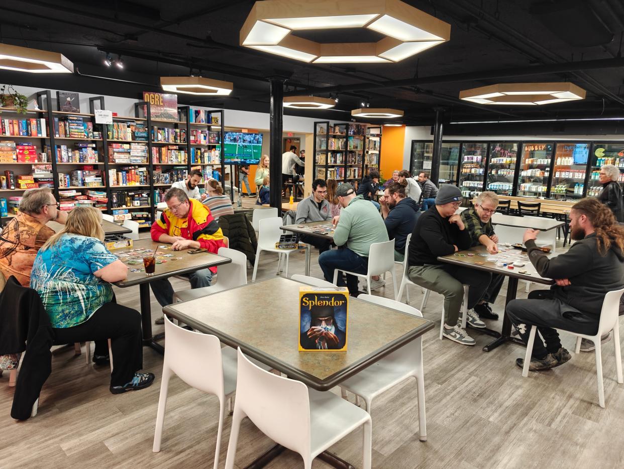 Patrons play board games at Hexagon Alley, 111 S. Ninth St. #10