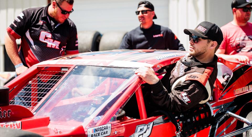 Tommy Catalano driver of the #54 FX Caprara car enter his car during the Duel at the Dog 200 for the Whelen Modified Tour at Monadnock Speedway on June 19, 2022 in Winchester, New Hampshire. (Nick Grace/NASCAR)