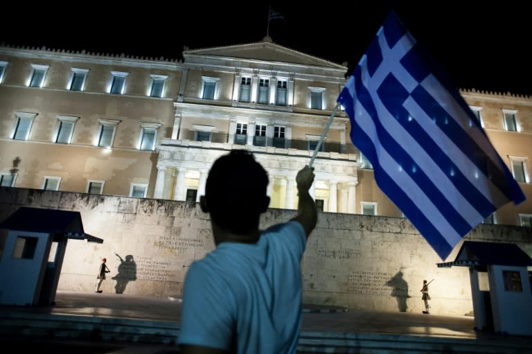 A man celebrates in front of the Greek parliament in Athens