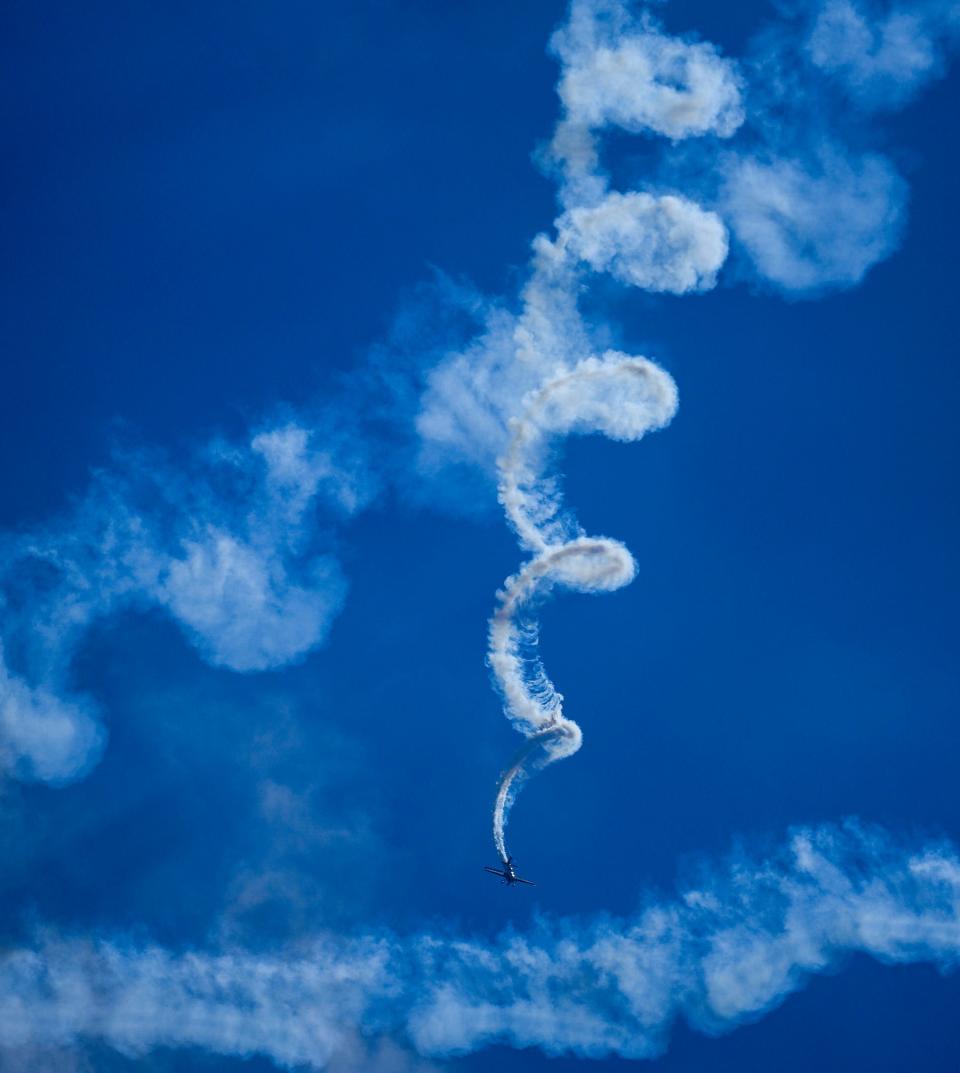 Kevin Coleman does tricks with the Red Bull plane during the Milwaukee Air & Water Show Saturday along Milwaukee's lakefront from McKinley to Bradford beaches.