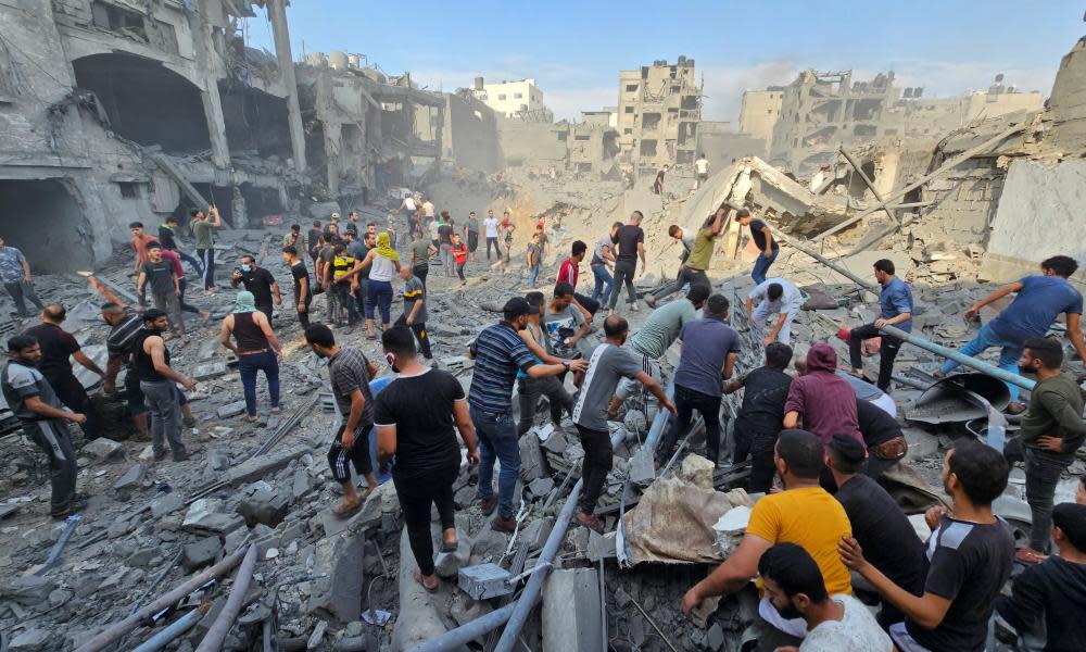 People search for casualties in Jabaliah refugee camp.