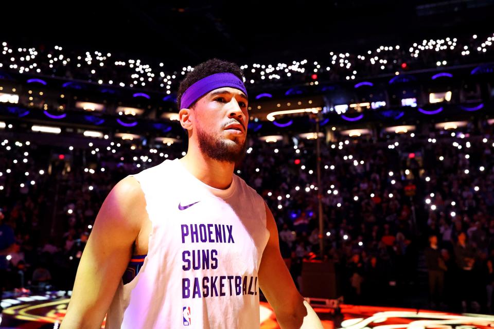 Phoenix Suns guard Devin Booker (1) is introduced before playing against the LA Clippers at Footprint Center in Phoenix on Jan. 3, 2024.