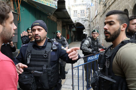 Israeli security forces block a man from entering an alley following a stabbing attack inside the old city of Jerusalem, April 1, 2017 REUTERS/Ammar Awad