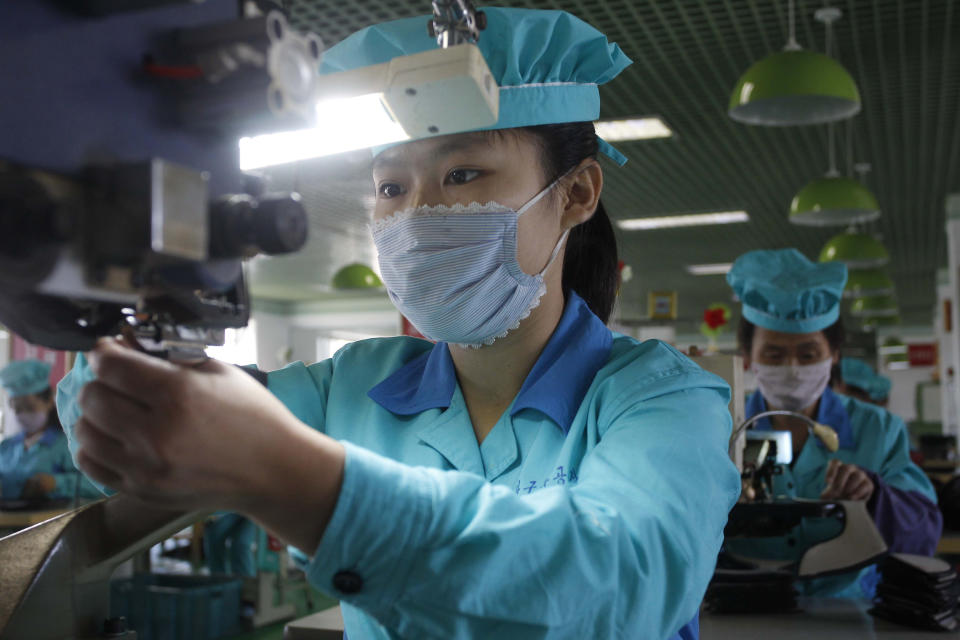 Employees assemble leather shoes at at the Wonsan Leather Shoes Factory in Wonsan, Kangwon Province, North Korea, on Oct. 28, 2020. North Korea is staging an “80-day battle,” a propaganda-heavy productivity campaign meant to bolster its internal unity and report greater production in various industry sectors ahead of a ruling party congress in January. (AP Photo/Jon Chol Jin)