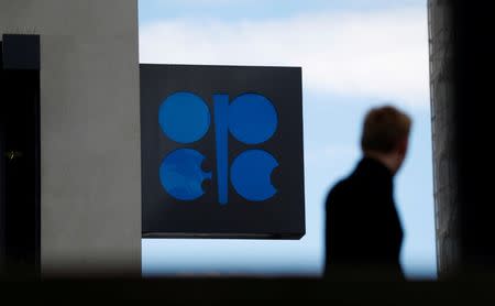 A person passes the logo of the Organization of the Petroleoum Exporting Countries (OPEC) in front of OPEC's headquarters in Vienna, Austria June 19, 2018. REUTERS/Leonhard Foeger/Files