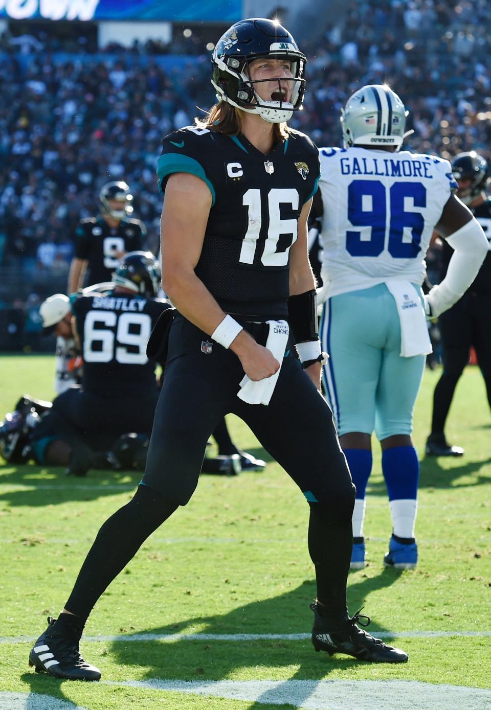 Jaguars quarterback Trevor Lawrence (16) celebrates after his touchdown pass to wide receiver Zay Jones (7) early in the fourth quarter gave the Jags the lead against the Cowboys on Dec. 18. Jacksonville eventually beat Dallas 40-34 in overtime.