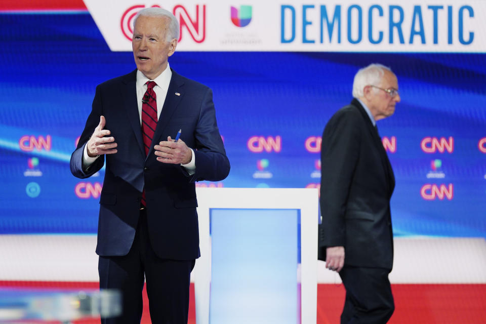 In this Sunday, March 15, 2020, photo, former Vice President Joe Biden prepares for a Democratic presidential primary debate with Sen. Bernie Sanders, I-Vt., at CNN Studios in Washington. Biden's status as Democratic presidential nominee-in-waiting means the party will choose another man for an office never held by a woman. But he's running with plenty of women behind him, including a yet-to-be-named vice presidential running mate. (AP Photo/Evan Vucci)