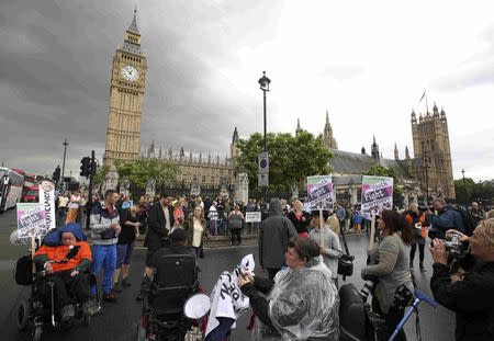 Demonstrators protest as Britain's Chancellor of the Exchequer George Osborne delivers his budget to the Hoiuse of Commons, in London, Britain July 8, 2015. REUTERS/Paul Hackett