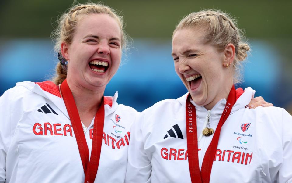 Silver medalist, Hope Gordon (L), and gold medalist, Charlotte Henshaw of Team Great Britain (R), celebrate during the medal ceremony for the Women's Va'a Single 200m VL3 Final A on day ten of the Paris 2024 Summer Paralympic Games at Vaires-Sur-Marne Nautical Stadium on September 07, 2024 in Paris, France.