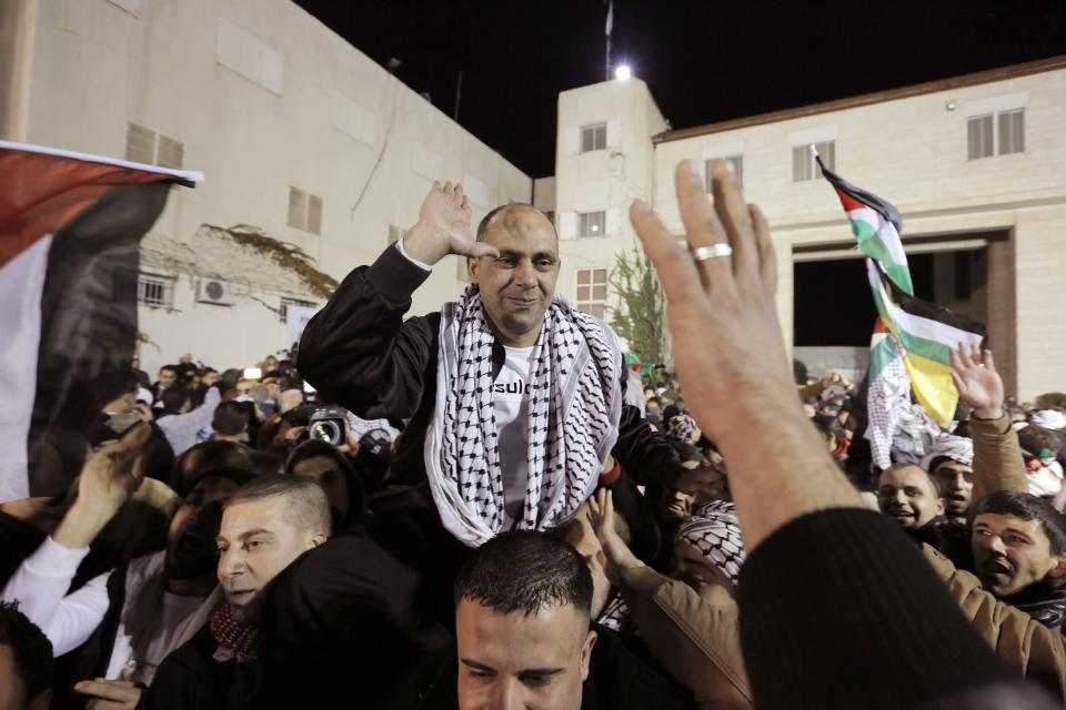 A prisoner released from Israeli prison is welcomed by relatives in the West Bank city of Ramallah