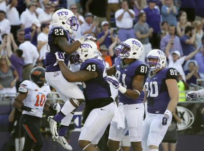 TCU running back B.J. Catalon (23) celebrates with teammates after scoring against Oklahoma State. (AP)