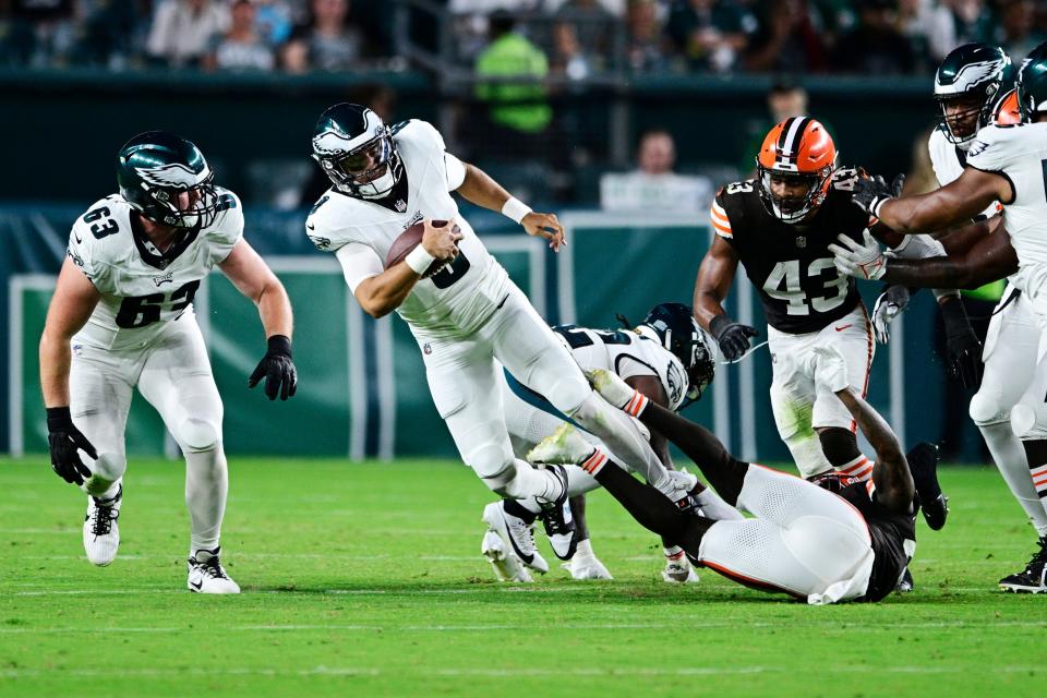 Philadelphia Eagles quarterback Marcus Mariota (8) is sacked by Cleveland Browns safety Tanner McCalister, bottom, Thursday in Philadelphia.