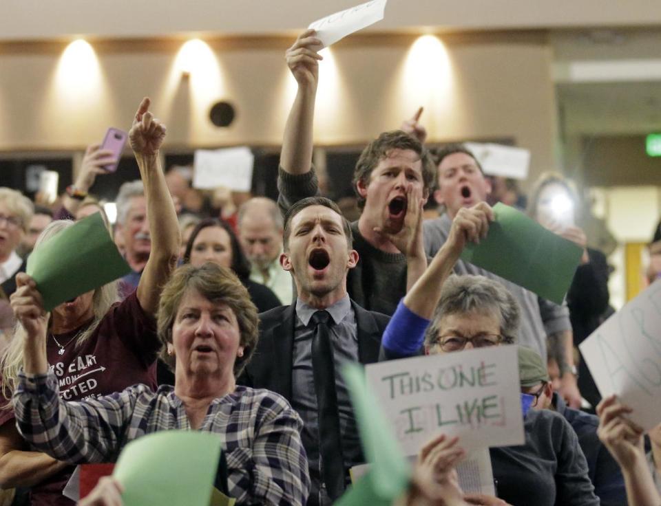 People shout to Rep. Jason Chaffetz during his town hall meeting at Brighton High School Thursday, Feb. 9, 2017, in Cottonwood Heights, Utah. Hundreds of people lined up early for a town hall with Chaffetz on Thursday evening, many holding signs criticizing the congressman's push to repeal the newly-named Bears Ears National Monument in southern Utah. (AP Photo/Rick Bowmer)