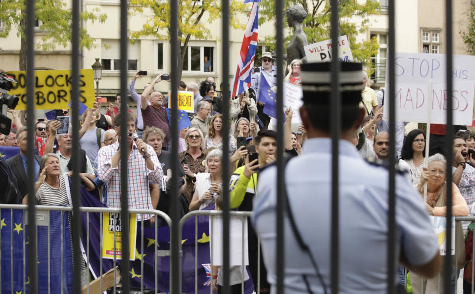 Pro-EU supporters hold signs during a demonstration outside a meeting between British Prime Minister Boris Johnson and Luxembourg's Prime Minister Xavier Bettel at the prime ministers office in Luxembourg, Monday, Sept. 16, 2019. (AP Photo/Olivier Matthys)