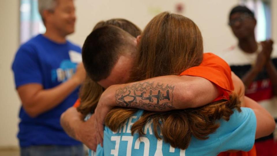 A father in Evans Correctional Institution in South Carolina embraces his two daughters at a Proverbs226 prison event. August 2023