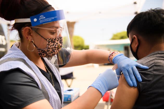 A 17-year-old receives a first dose of the Pfizer COVID-19 vaccine at a clinic in Los Angeles. Regular vaccinations have been down for children in the U.S. since the start of the pandemic, raising concerns of a resurgence of vaccine-preventable diseases and infections. (Photo: PATRICK T. FALLON via Getty Images)