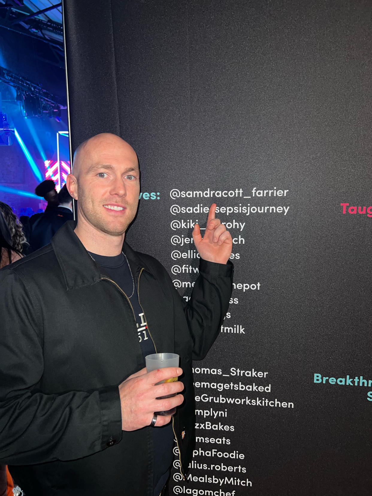 Man points to his name written on a wall