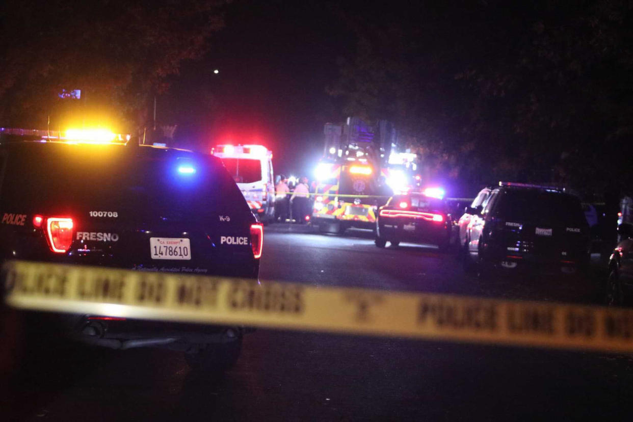 Police and emergency vehicles work at the scene of a shooting at a backyard party, Sunday, Nov. 17, 2019, in southeast Fresno, Calif. (Photo: Larry Valenzuela/The Fresno Bee via AP)