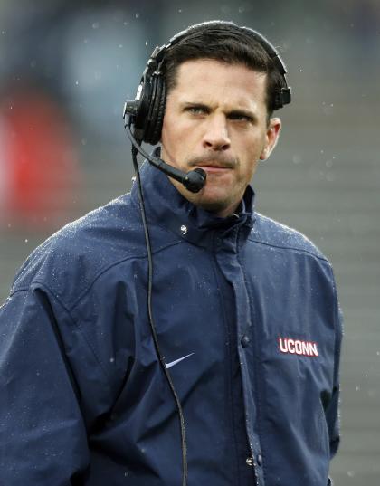 FILE- In this Nov. 1, 2014 file photo, Connecticut head coach Bob Diaco watches from the sideline during the first quarter of an NCAA college football game against Central Florida in East Hartford, Conn. Diaco is looking forward to the team&#39;s big rivalry game with UCF this fall, and he&#39;s put a countdown clock in the school&#39;s training facility right above the game trophy. UCF&#39;s coach, on the other hand, says he didn&#39;t know there was a trophy, or a rivalry. (AP Photo/Michael Dwyer, File)