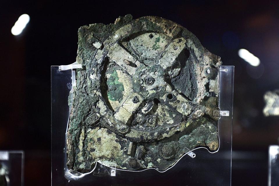 A picture taken at the Archaeological Museum in Athens on September 14, 2014 shows a piece of the so-called Antikythera Mechanism, a 2nd-century BC device known as the world's oldest computer, which was discovered by sponge divers in 1900 off a remote Greek island in the Aegean. Source: Getty