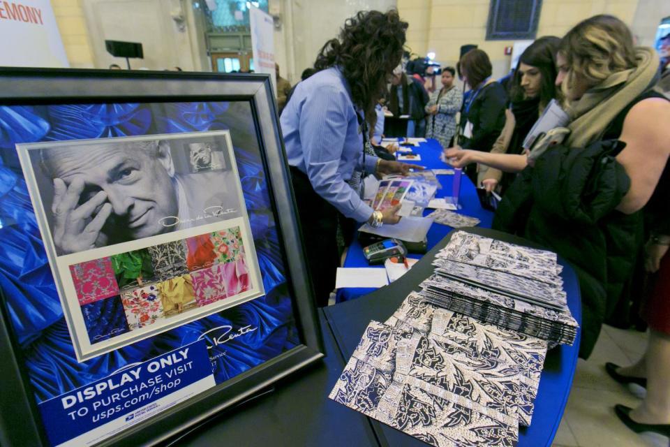 Commemorative stamps honoring the late fashion designer Oscar de la Renta are displayed for sale after an unveiling at Grand Central Terminal in New York, Thursday, Feb. 16, 2017. (AP Photo/Richard Drew)