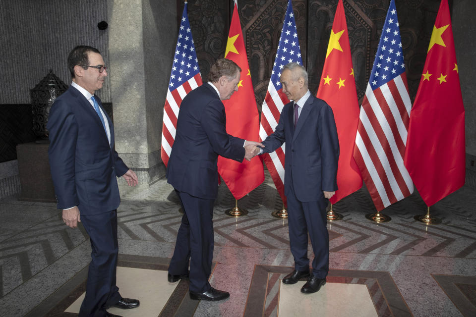 CORRECTS SPELLING TO STEVEN INSTEAD OF STEVE -Chinese Vice Premier Liu He, right, welcomes U.S. Trade Representative Robert Lighthizer, center, and Treasury Secretary Steven Mnuchin, left, before holding talks at the Xijiao Conference Center in Shanghai Wednesday, July 31, 2019. (AP Photo/Ng Han Guan, Pool)