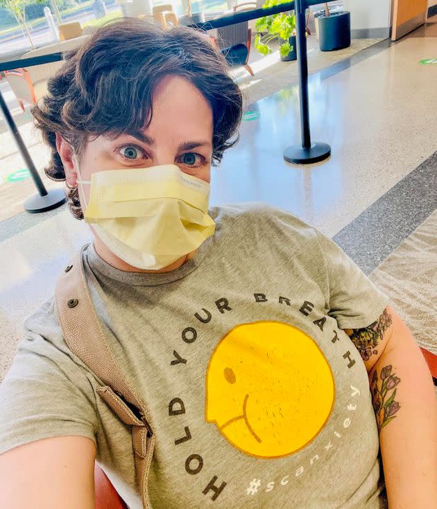 Almost a year after completing chemotherapy, the author waits in the hospital lobby, masked and by herself, as she did for most of her cancer treatment. (Photo: Courtesy of Kari Neumeyer)