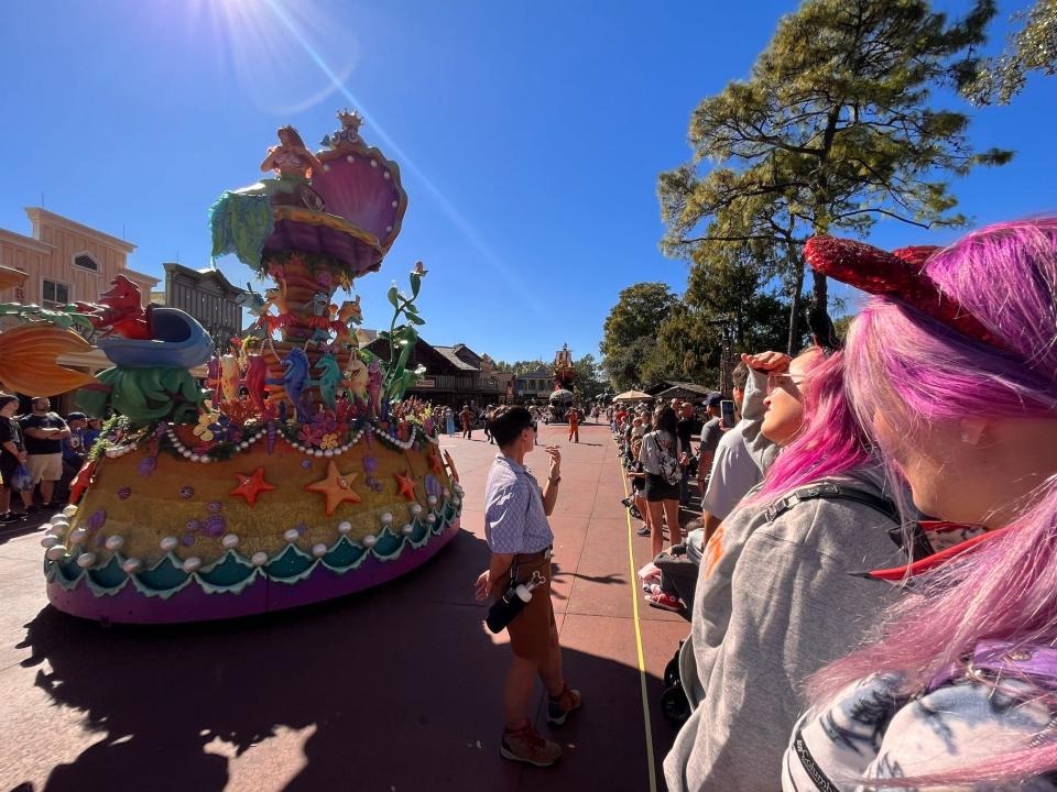 casey watching the dumbo float of the festival of fantasy parade at magic kingdom in disney world