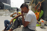 From left, construction workers Santiago Gomez, Jorge Moreno, Abel Lozano take a break from the extreme heat during a road construction project in downtown Chicago, Thursday, June 28, 2012. Temperatures in the city were expected to reach 96 Thursday with little relief expected in the next few days. (AP Photo/Sitthixay Ditthavong)