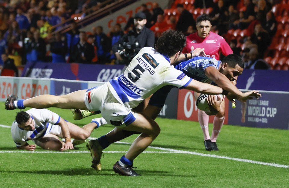 Samoa's Matt Feagai, right, is pushed into touch by Greece's Jonathan Mitsias, during the Rugby League World Cup group A match between Samoa and Greece, at the Eco-Power Stadium, in Doncaster, England, Sunday, Oct. 23, 2022. (Richard Sellers/PA via AP)