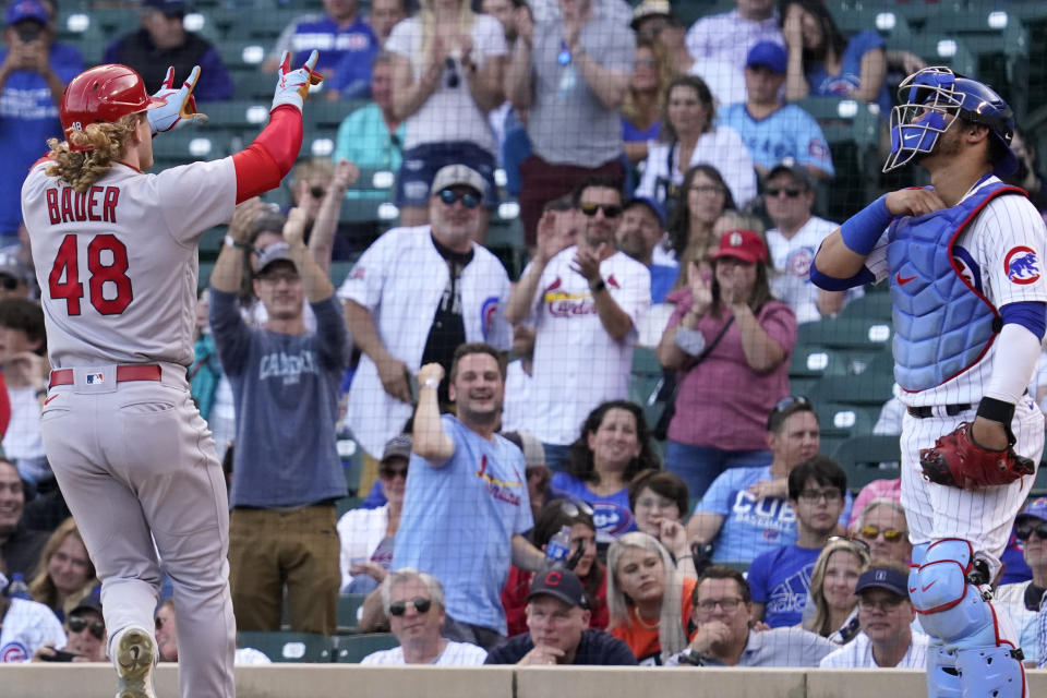 St. Louis Cardinals' Harrison Bader, left, celebrates after hitting a solo home run as Chicago Cubs catcher Willson Contreras looks up during the eighth inning of a baseball game in Chicago, Sunday, Sept. 26, 2021. (AP Photo/Nam Y. Huh)