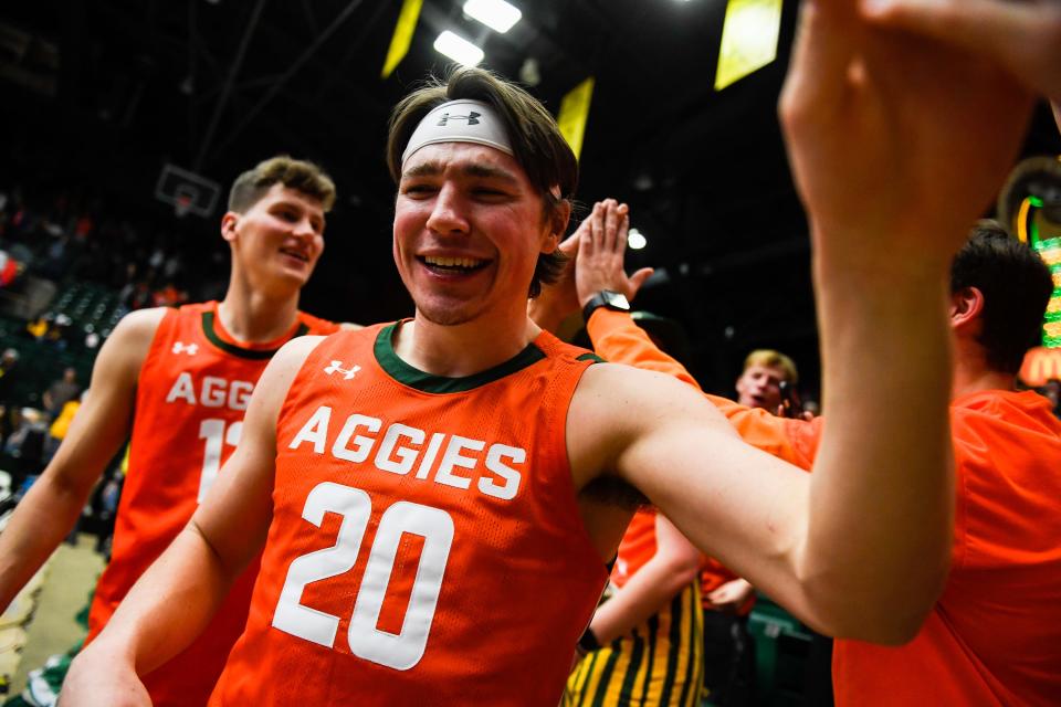 Colorado State's Joe Palmer (20) high fives fans after a college basketball game against Wyoming at Moby Arena on Friday, Feb. 24, 2023 in Fort Collins, Colo. The Rams won 84-71.