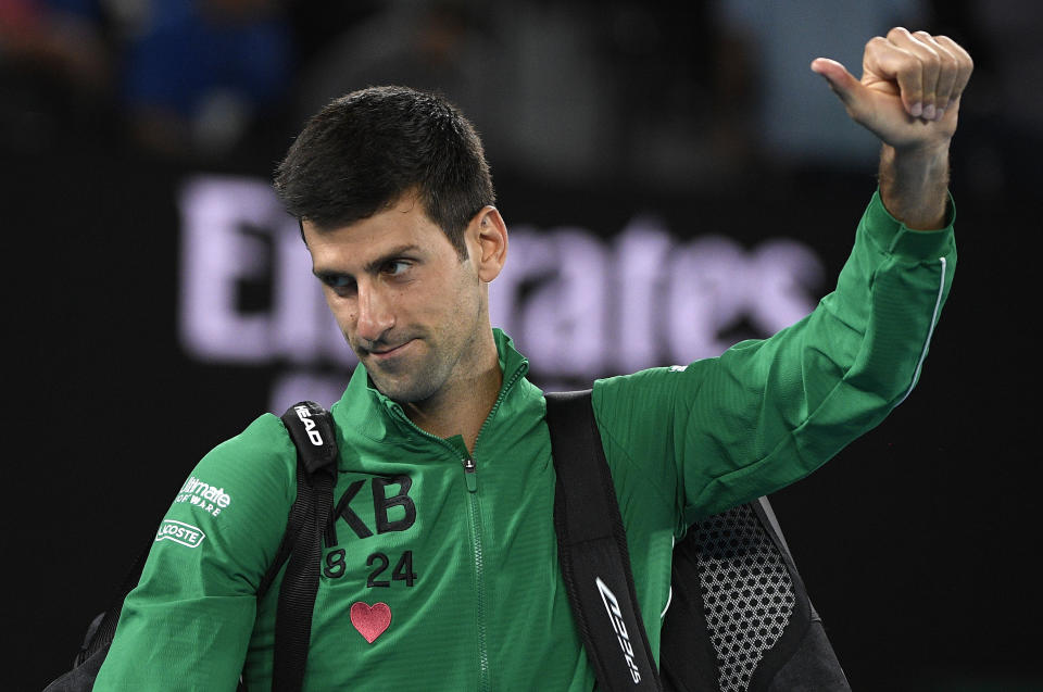 Serbia's Novak Djokovic gestures as he leaves Rod Laver Arena after defeating Canada's Milos Raonic in their quarterfinal match at the Australian Open tennis championship in Melbourne, Australia, Tuesday, Jan. 28, 2020. (AP Photo/Andy Brownbill)