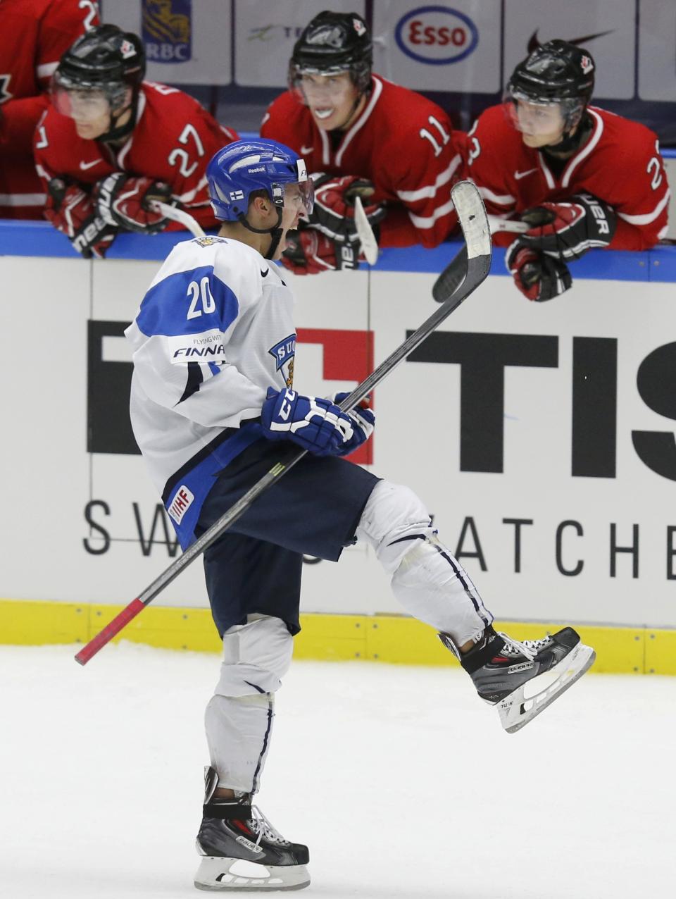 Finland's Teuvo Teravainen celebrates in front of Canada's bench after scoring on a penalty shot during the third period of their IIHF World Junior Championship ice hockey game in Malmo, Sweden, January 4, 2014. REUTERS/Alexander Demianchuk (SWEDEN - Tags: SPORT ICE HOCKEY)