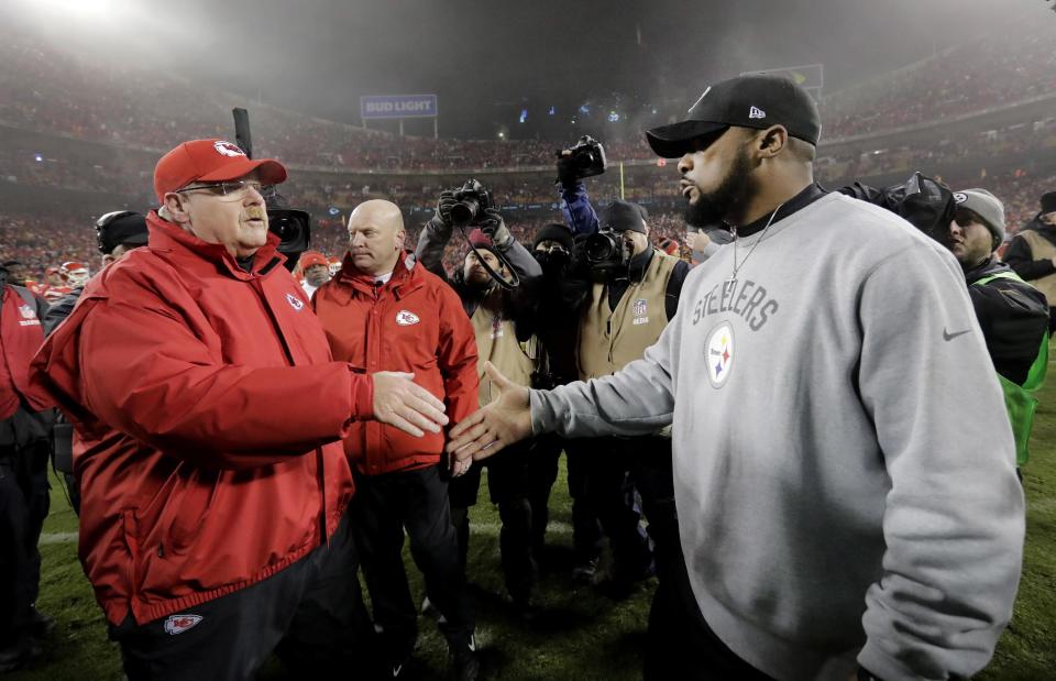 Kansas City Chiefs head coach Andy Reid, left, talks with Pittsburgh Steelers head coach Mike Tomlin, right, after an NFL divisional playoff football game Sunday, Jan. 15, 2017, in Kansas City, Mo. The Steelers won 18-16. (AP Photo/Charlie Riedel)