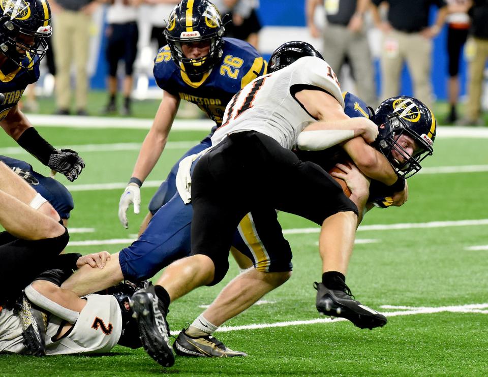 Shea Ruddy of Whiteford plows forward for a first down as Luke Volmering of Ubly brings him down, which lead to the final touchdown in the fourth quarter. Whiteford beat Ubly 26-20 in the Division 8 State Championships at Ford Field Friday.