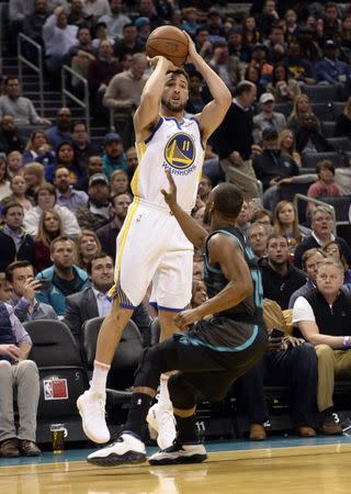 Feb 25, 2019; Charlotte, NC, USA; Golden State Warriors guard forward Klay Thompson (11) shoots as he is defended by Charlotte Hornets guard Kemba Walker (15) during the first half at the Spectrum Center. Mandatory Credit: Sam Sharpe-USA TODAY Sports