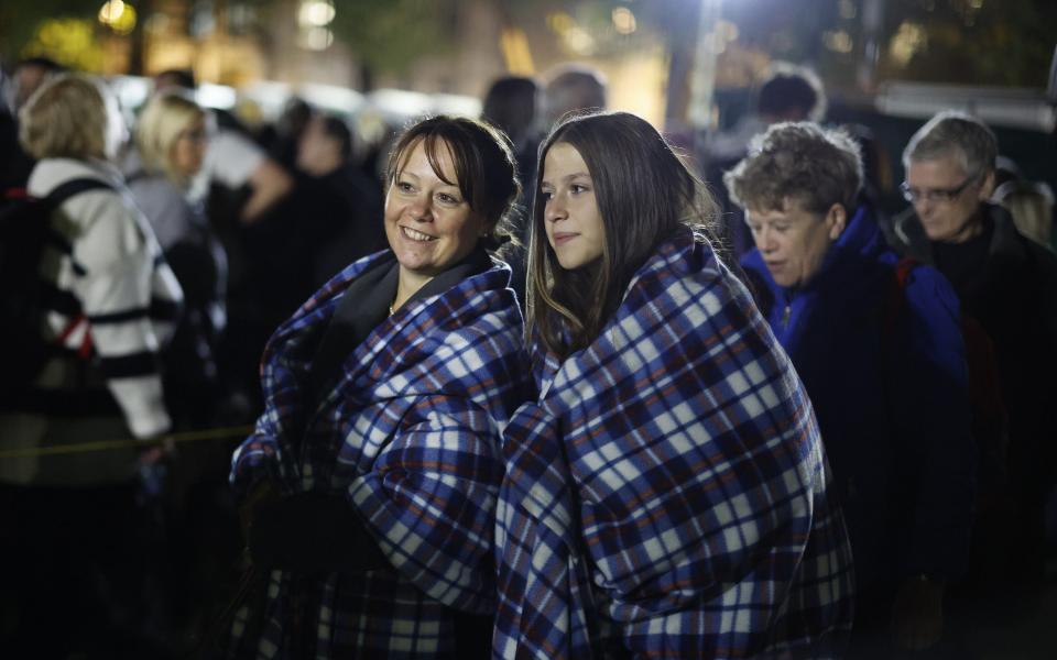 Bundled up against the cold, members of the public queue to view the Queen's coffin - Getty Images