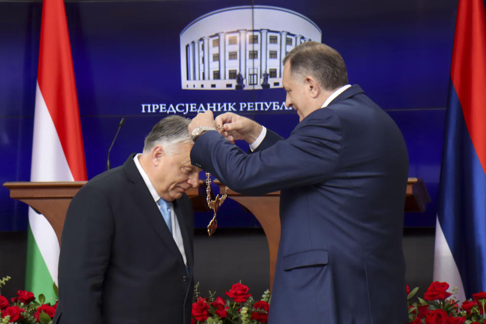 In this photograph made available by the Republika Srpska Presidential Press Service, Hungary's Prime Minister Viktor Orban, left, receives the Order of Republika Srpska from Bosnian Serb leader Milorad Dodik during his visit in Banja Luka, Bosnia, Friday, April 5, 2024. Orban is on a two-day visit to Bosnia and Herzegovina. (Republika Srpska Presidential Press Service via AP)