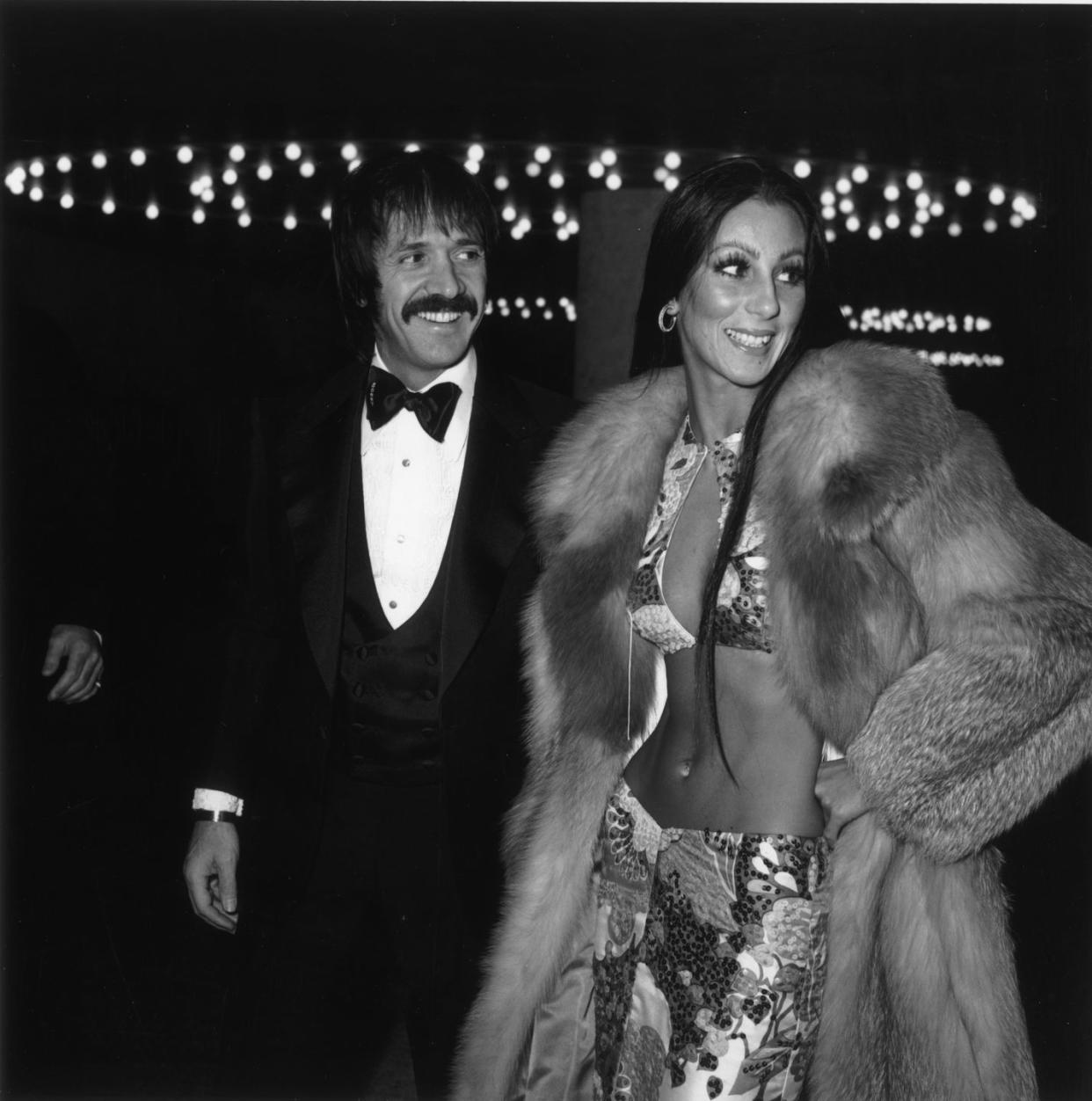 1973 american singers sonny and cher attend the golden globe awards, los angeles, california sonny bono 1935 1998 wears a tuxedo cher wears a midriff baring two piece outfit and fur coat photo by max b millerfotos internationalgetty images