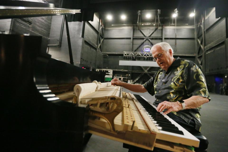 Charles Ball demonstrates how to tune a piano at the Long Center. Ball met and tuned instruments for many of the world's most famous pianists during his decades-long career.