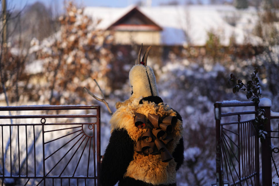 A reveler depicting devil takes part in a traditional St. Nicholas procession in the village of Lidecko, Czech Republic, Monday, Dec. 4, 2023. This pre-Christmas tradition has survived for centuries in a few villages in the eastern part of the country. The whole group parades through village for the weekend, going from door to door. St. Nicholas presents the kids with sweets. The devils wearing home made masks of sheep skin and the white creatures representing death with scythes frighten them. (AP Photo/Petr David Josek)