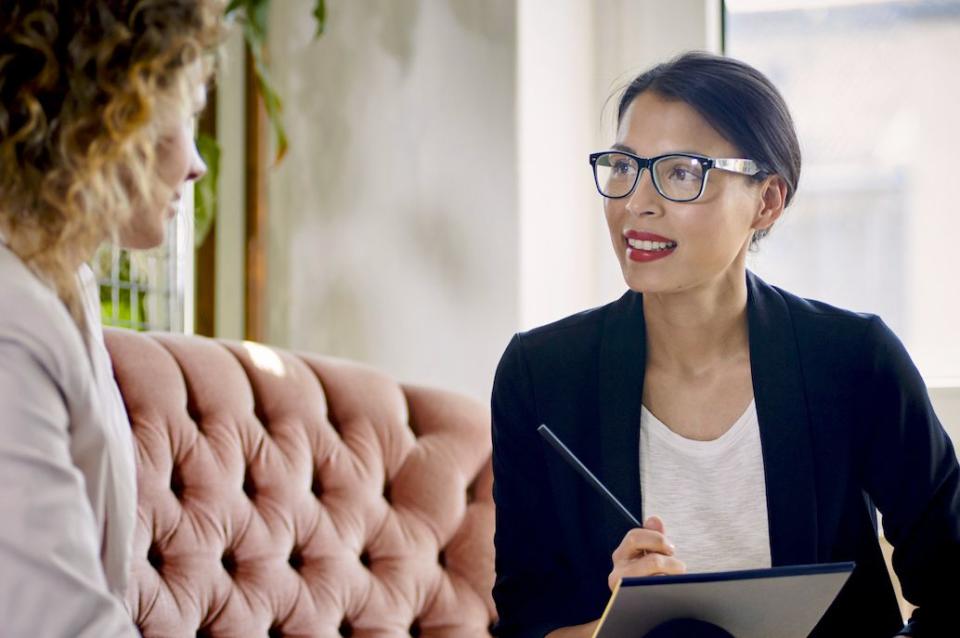 coworker sitting on sofa in office